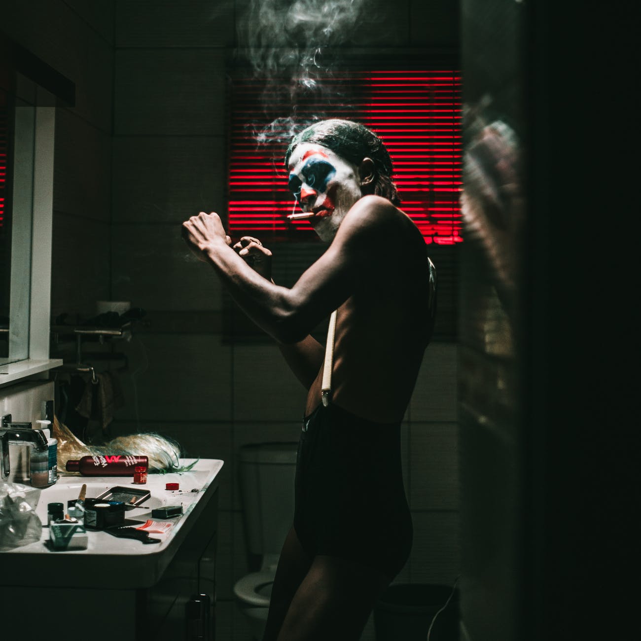 man wearing joker face paint